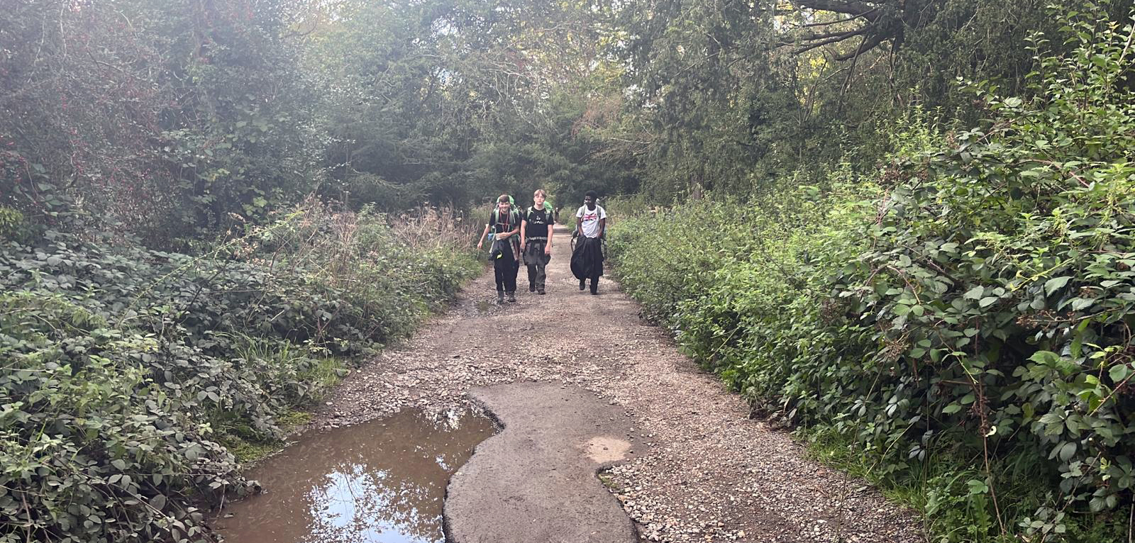 Three students on a hike in the woods fior their Duke of Edinburgh award