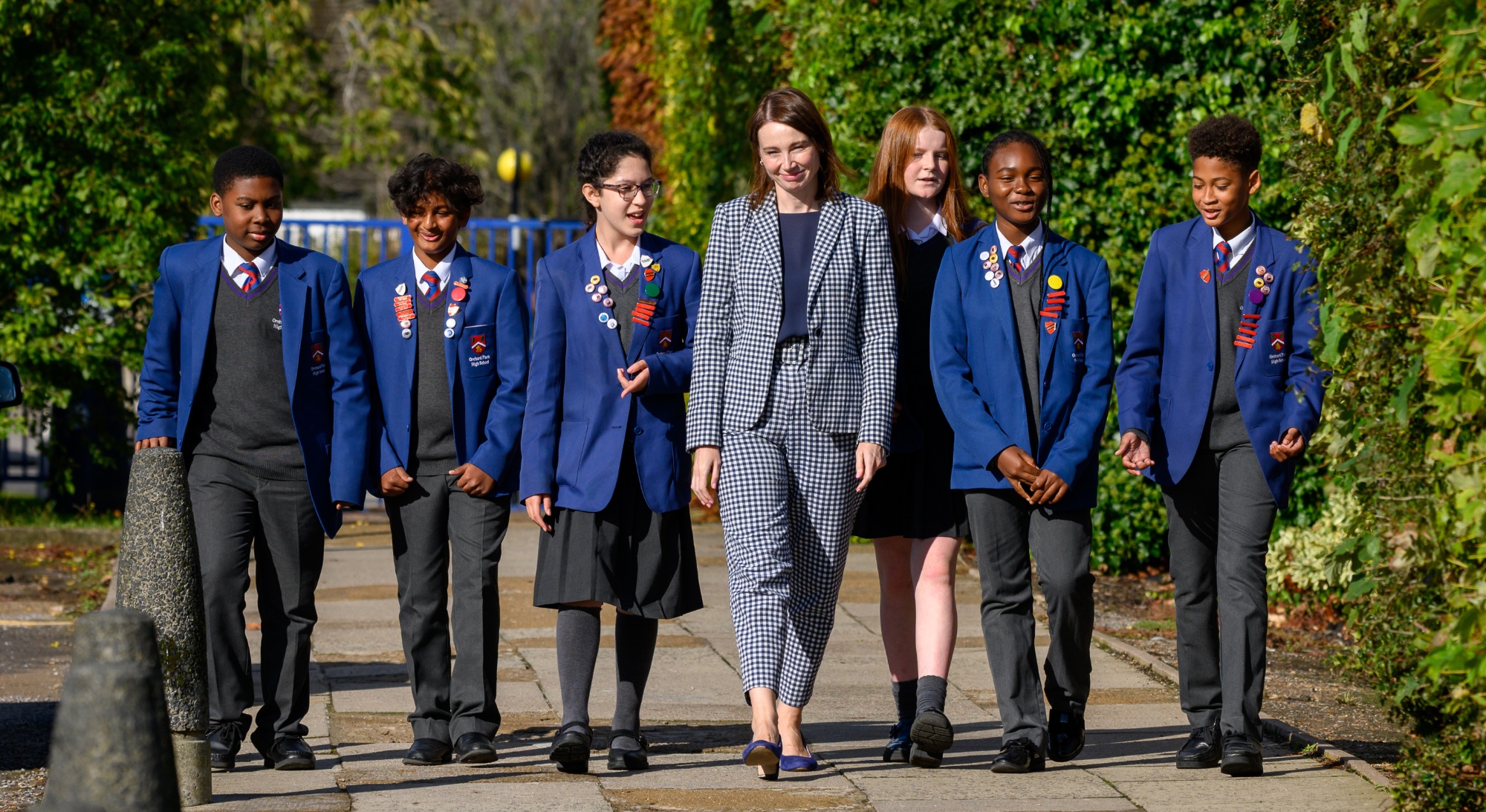 Headteacher walking with a group of students.