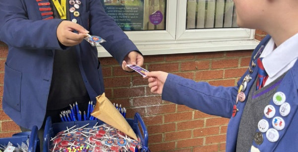 Student at a stall handing out the rewards